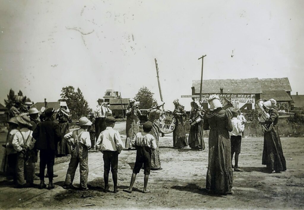 Vintage street band performing outdoors for a crowd.