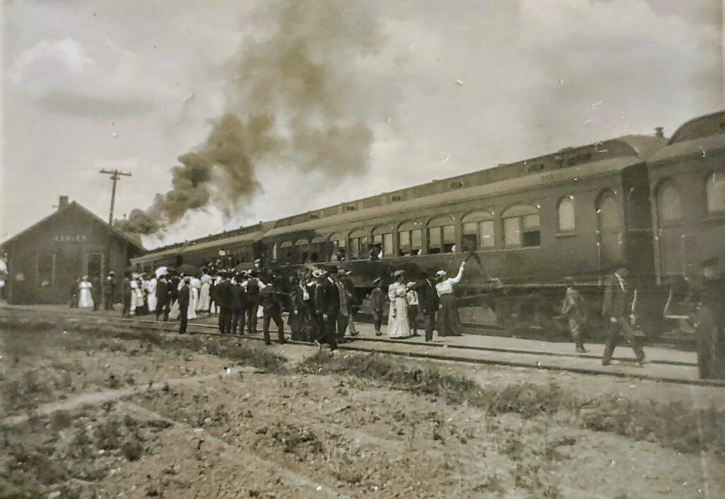 Historic steam train with people at station